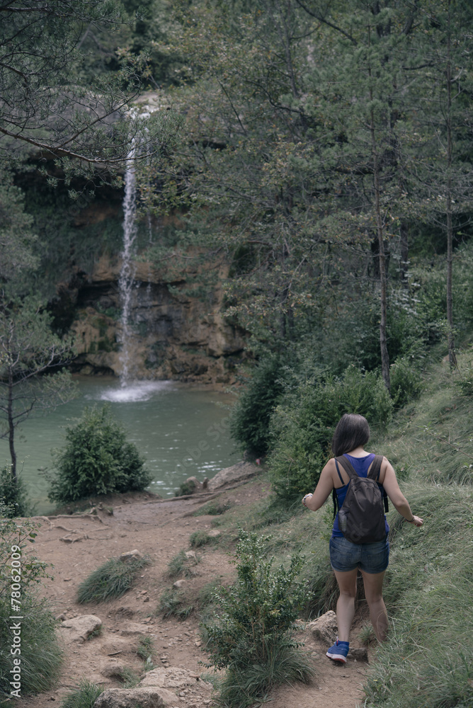 young tourist in the mountains with his arms raised young tourist in the mountains with his arms raised