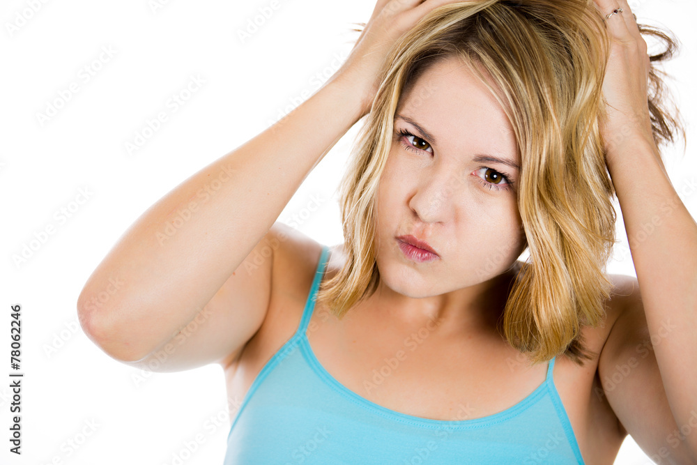 Frustrated stressed young woman pulling her hair out