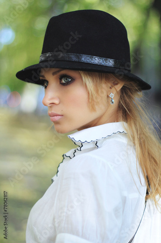 Profile of a girl in black hat © glebchik