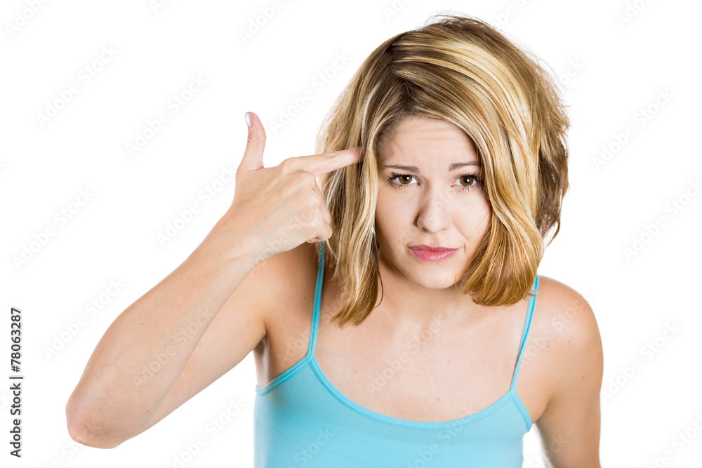 Woman gesturing with finger against temple asking are you crazy 