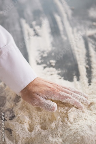 Close up of baker preparing dough
