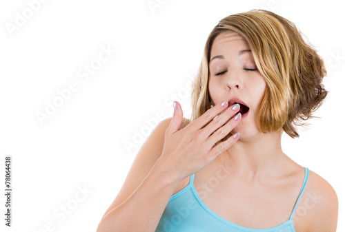 Portrait sleepy yawning woman covering her open mouth 