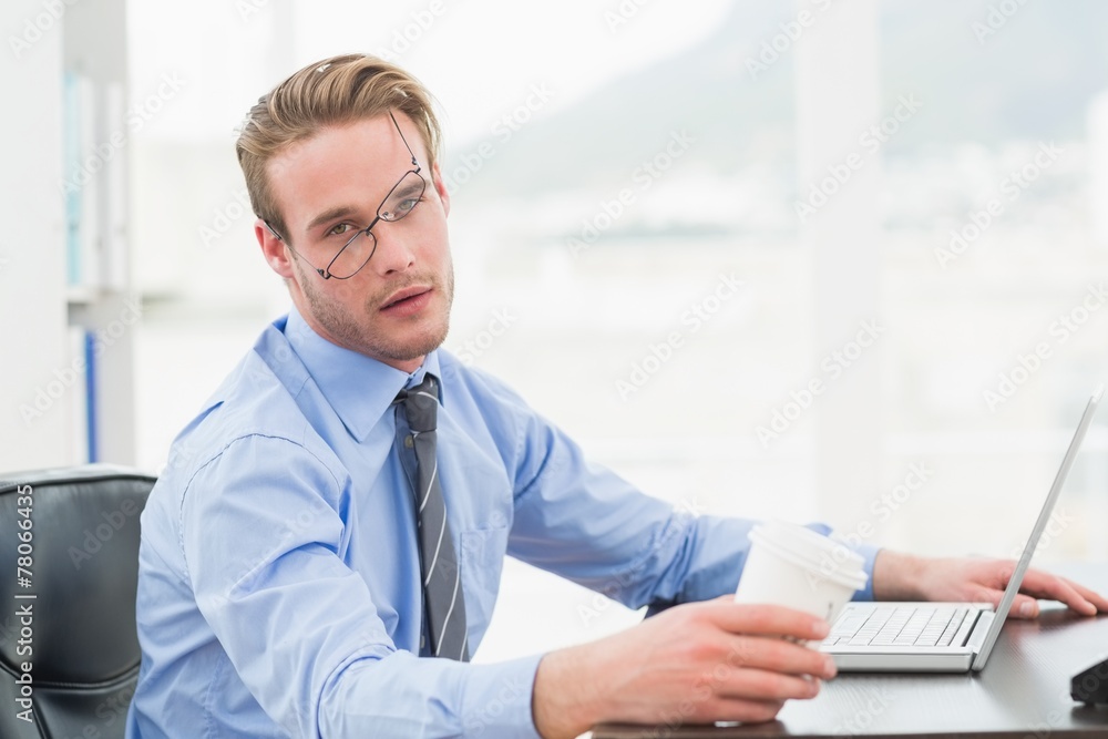 Tired businessman waking up with coffee cup Tired businessman waking up with coffee cup