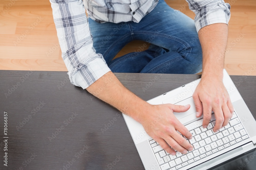 Fototapeta premium A man sitting on the floor at home