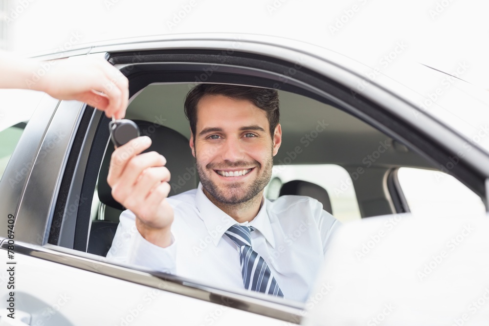 Businessman getting his new car key