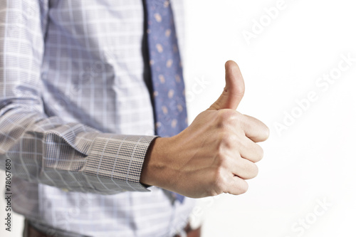 Businessman showing thumb up gesture