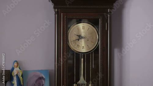 Old antique clock with statuette of the Virgin Mary