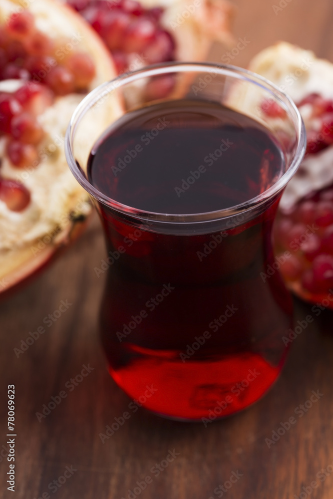 Ripe pomegranates with juice on table Ripe pomegranates with juice on table