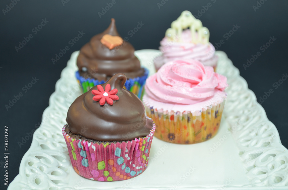 Cupcake with chocolate sauce and flower decoration