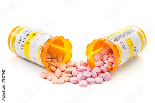 Prescription medication in pharmacy vials on a white surface