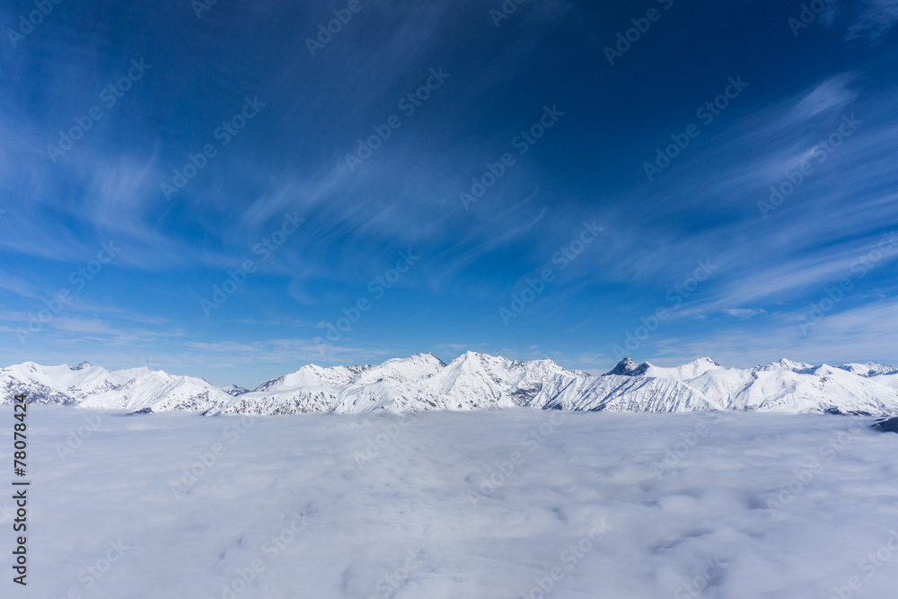 View on mountains and blue sky above clouds