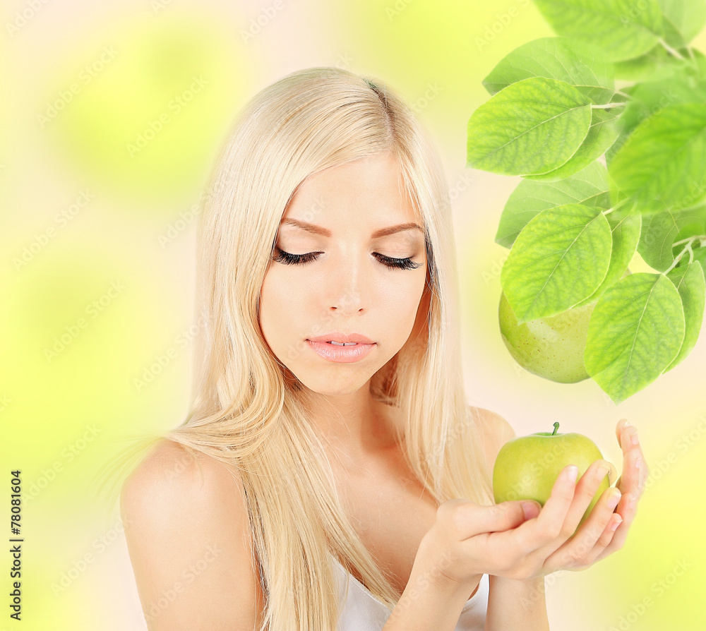 Beautiful young woman with green apple on natural background Beautiful young woman with green apple on natural background