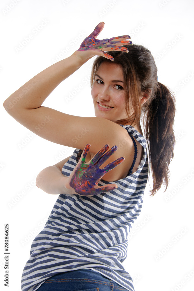 Woman smiling and showing her hands painted in colorful paint Woman smiling and showing her hands painted in colorful paint