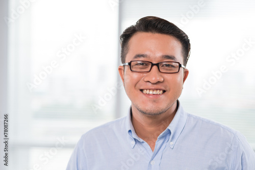 Smiling Vietnamese man in glasses photo
