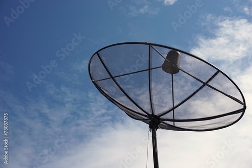 black satellite dish with the blue sky
