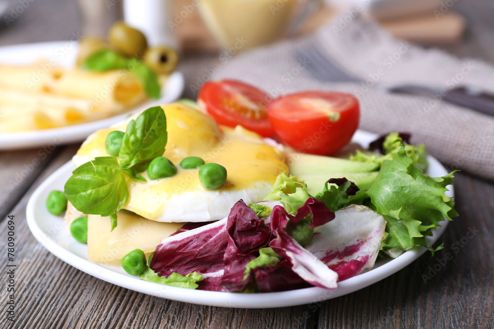 Toast with egg Benedict and avocado on plate on wooden table Toast with egg Benedict and avocado on plate on wooden table