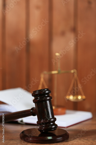 Wooden judges gavel on wooden table, close up