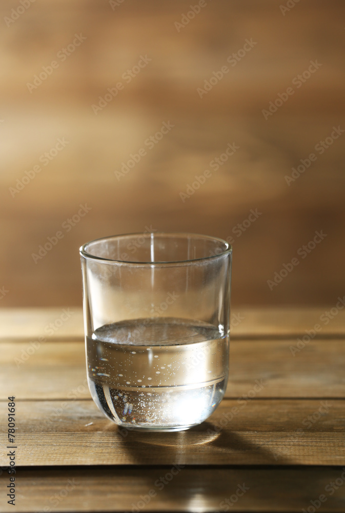 Glass of clean mineral water on rustic wooden background Glass of clean mineral water on rustic wooden background
