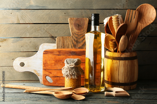 Wooden kitchen utensils with glass bottle of olive oil