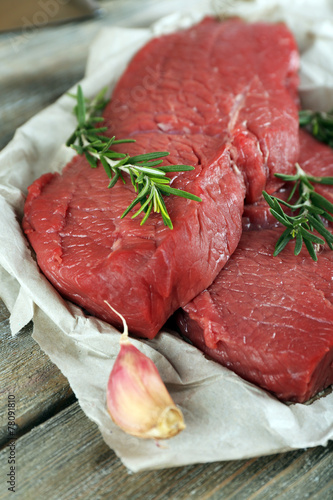 Raw beef steak with rosemary and garlic