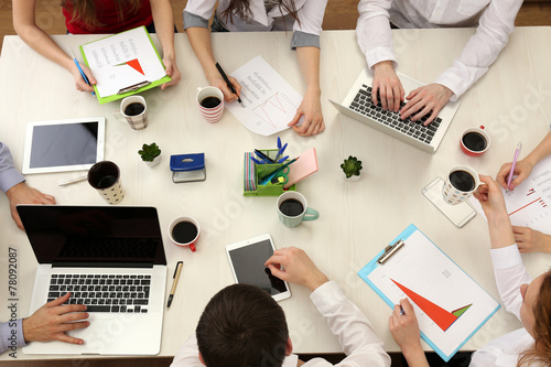 Group of business people working at desk top view photo