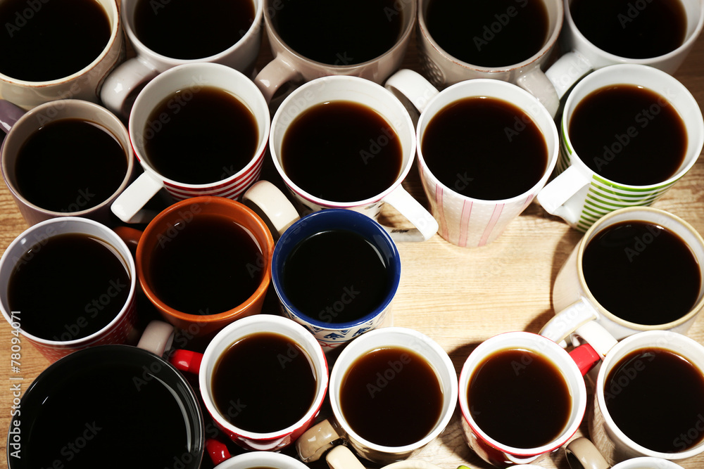Many cups of coffee on wooden table background, closeup view Many cups of coffee on wooden table background, closeup view