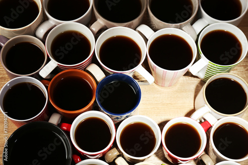 Many cups of coffee on wooden table background, closeup view