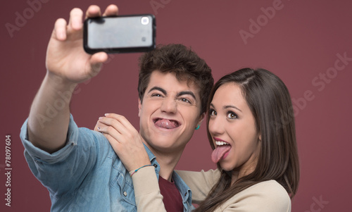 Young couple taking selfies