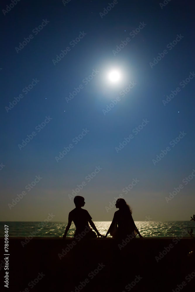 Yong Couple Is Sitting Under The Moon And Stars On The Tropical Stock Photo Adobe Stock Yong Couple Is Sitting Under The Moon And Stars On The Tropical Stock Photo Adobe Stock