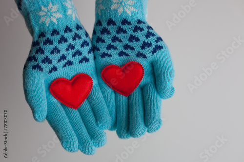 Tableau sur toile Read hearts in hands in warm gloves for Valentine's Day