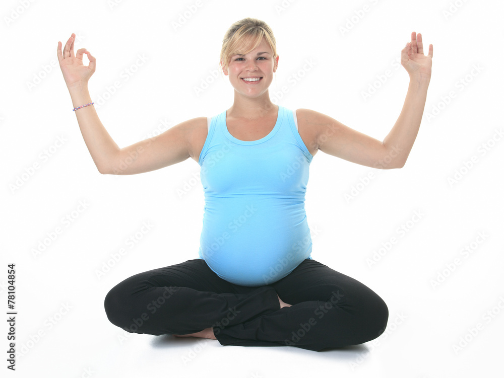 Pregnant woman relax doing yoga, sitting in lotus position over Pregnant woman relax doing yoga, sitting in lotus position over