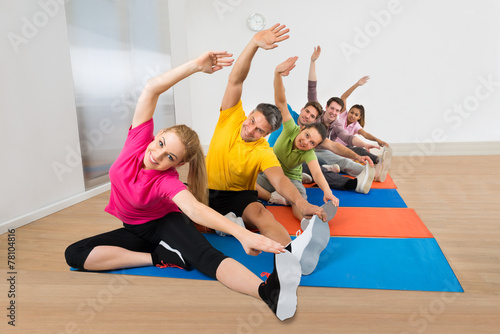 Group Of Happy People Stretching Legs