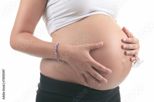 Photo of a pregnant woman over studio white background