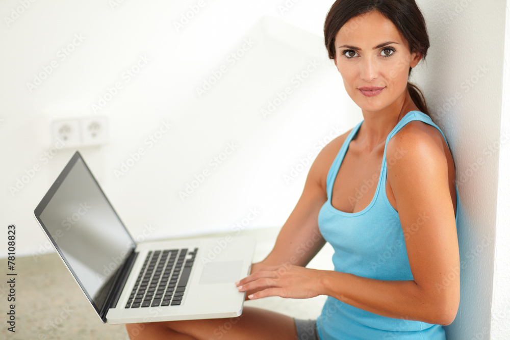 Fit woman in sportswear using her computer Fit woman in sportswear using her computer