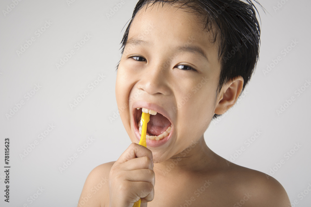 The boy brushing to clean his teeth. The boy brushing to clean his teeth.