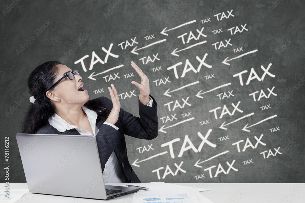 Frustrated female manager paying tax Frustrated female manager paying tax