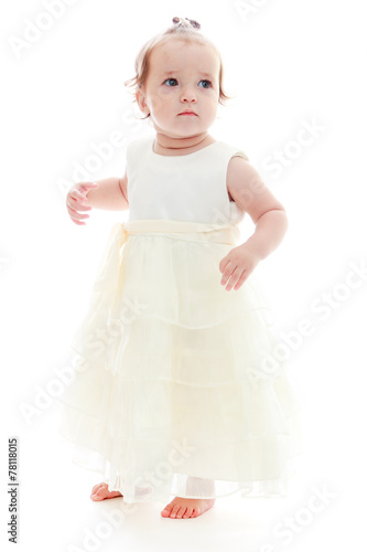 Cute little girl in a white dress