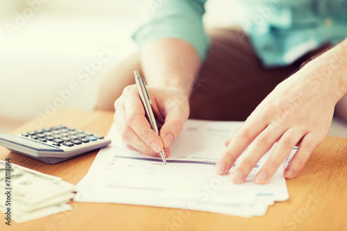 close up of man counting money and making notes