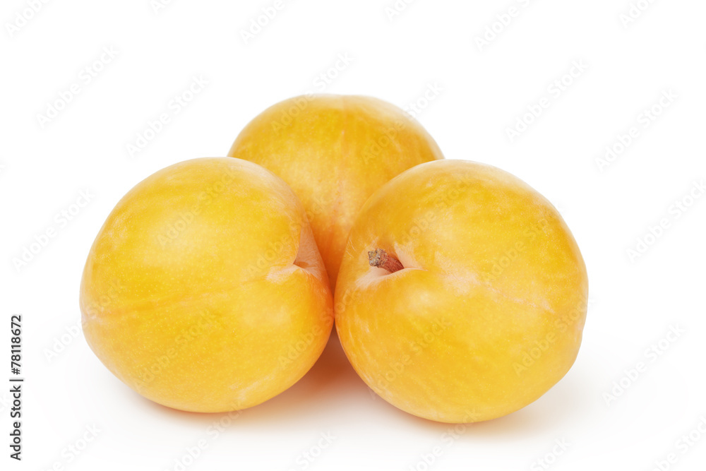 three ripe yellow plums