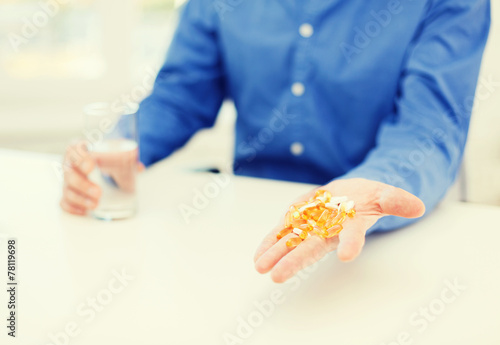 close up of male hand showing lot of pills
