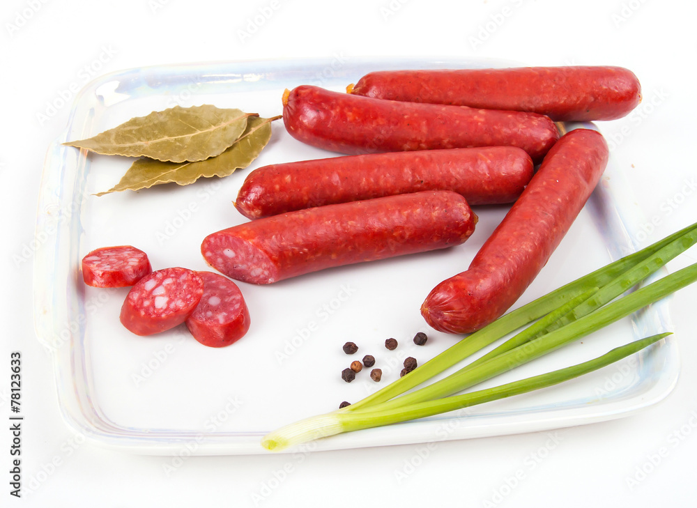 Smoked sausages on plate isolated on white background Smoked sausages on plate isolated on white background