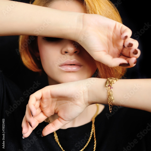 Young woman with red hair closes eyes hand