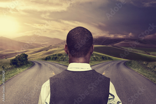 businessman in front of two roads hoping taking chance photo