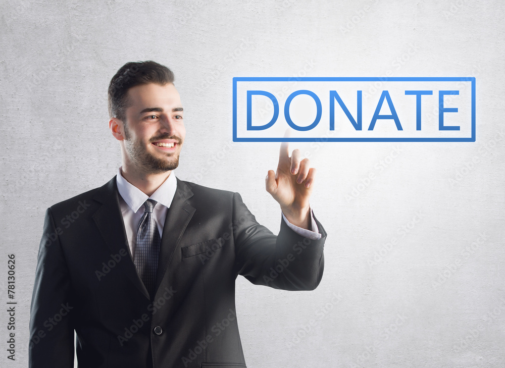 Businessman pressing a donate sign Businessman pressing a donate sign