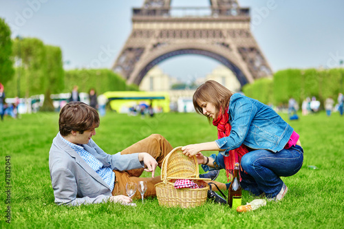 Couple having a picnic near the Eiffel tower photo