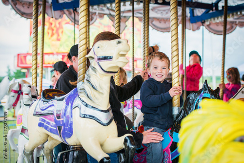 Excited Boy on a Carousel Horse