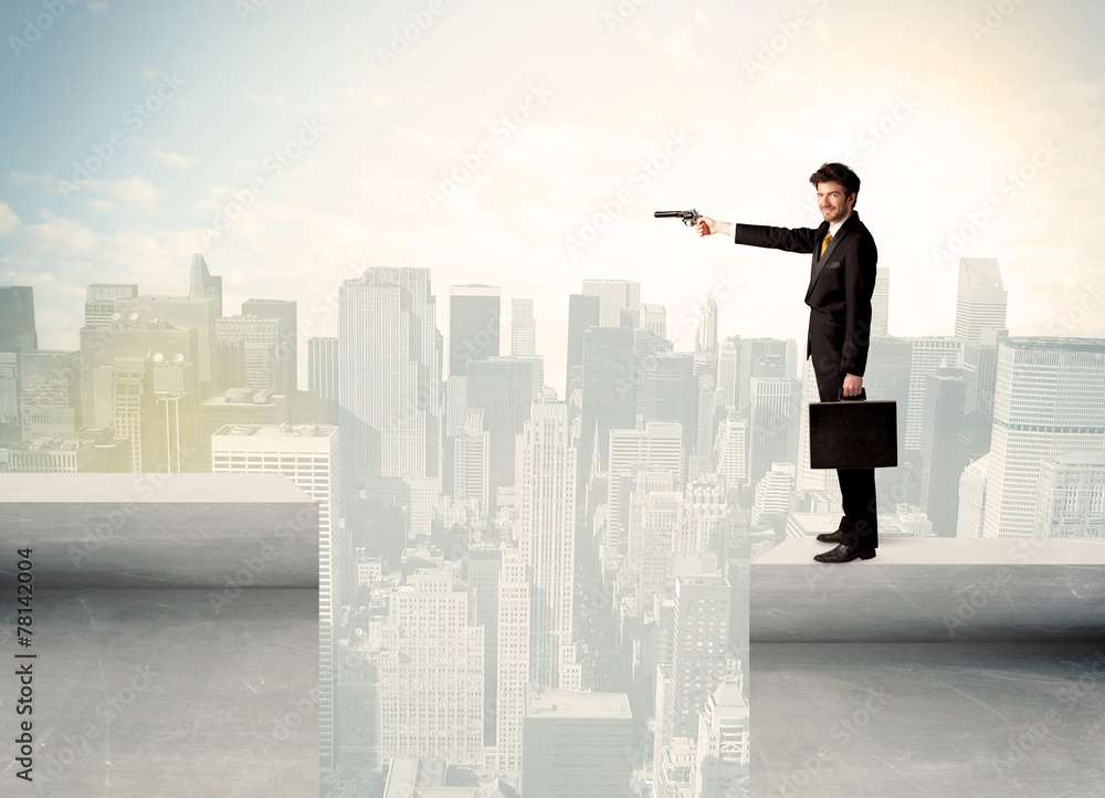 Businessman standing on the edge of rooftop Businessman standing on the edge of rooftop