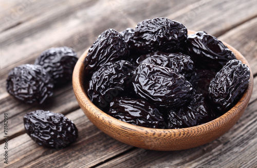 Prunes on a wooden background