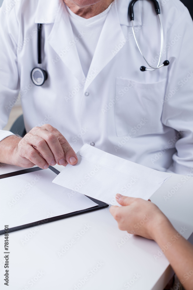 Doctor accpeting an envelope Doctor accpeting an envelope