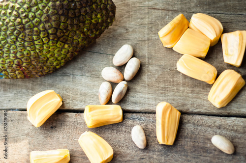 bright yellow pieses of jackfruit on wooden background